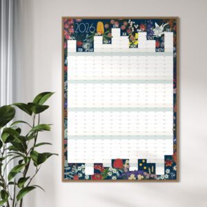 Wildflower wall planner 2026 framed on a wall with a plant